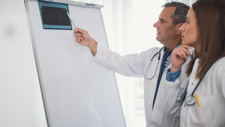 Featured Image – Constructive Feedback- A Guide for Managers Concentrated medical colleagues examining x-ray together